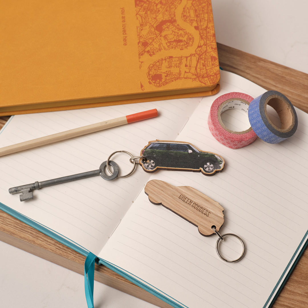 Wooden keychains green goddess car keyring and a pen on an open notebook with washi tape. Personalise with your own text and choice of Mini colour to make a one of a kind daddy gift or stocking filler for car enthusiasts.