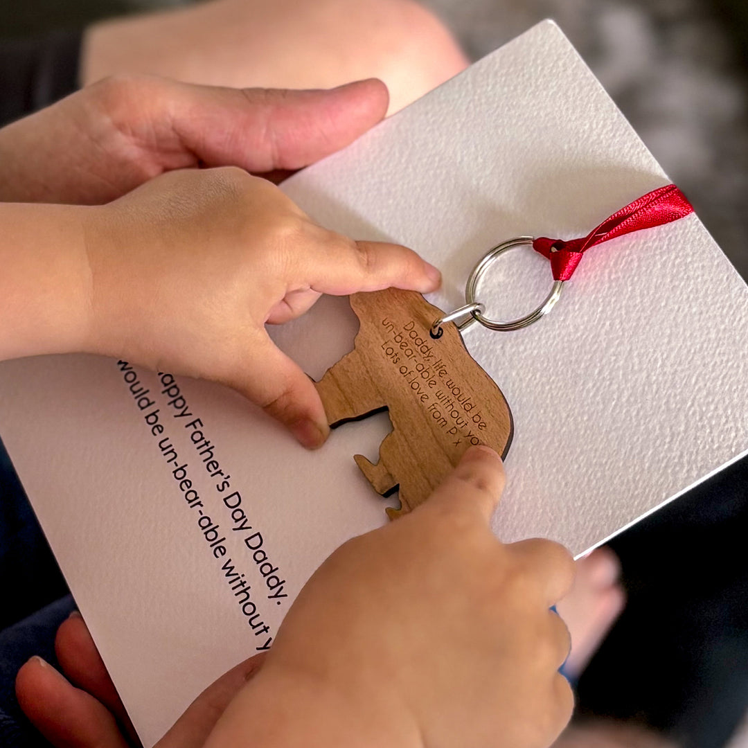 Unique Father’s Day present – customisable bear keyring on printed message card, young girl holding bear, reading message on the reverse