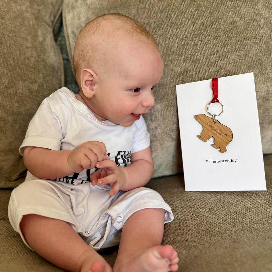 Unique Father’s Day present – customisable bear keyring on printed message card, baby sat next to card showing message on the reverse