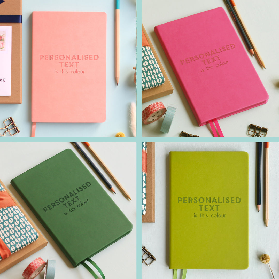 An image split into quarters. Each quarter contains a notebook image showing how the notebook will engrave in that colour.