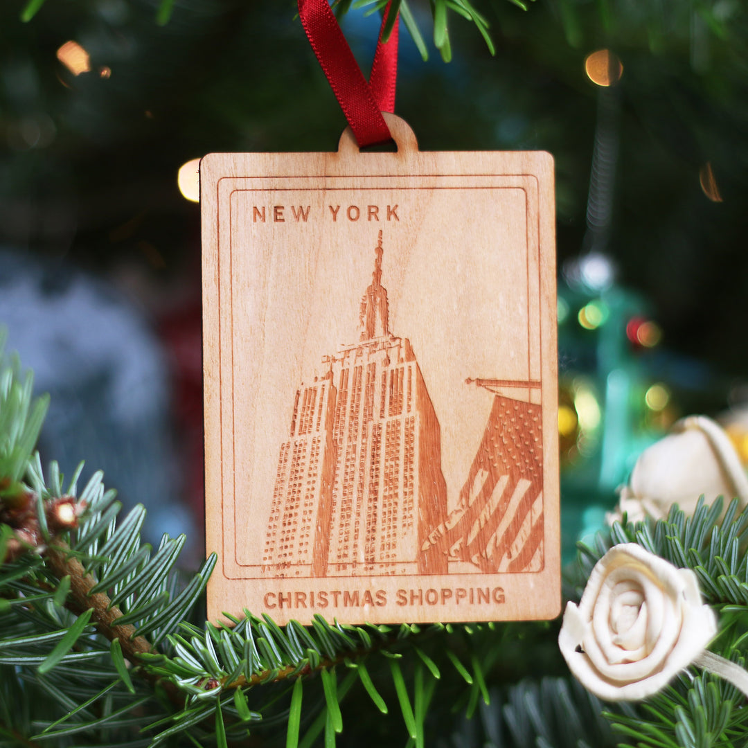 New York travel memory anniversary gift, commemorate your Christmas memories, with this sustainable wood cherry veneered ornament with Empire State Building design on a Christmas tree. Personalise the location and text for a perfect letterbox friendly gift for travellers.