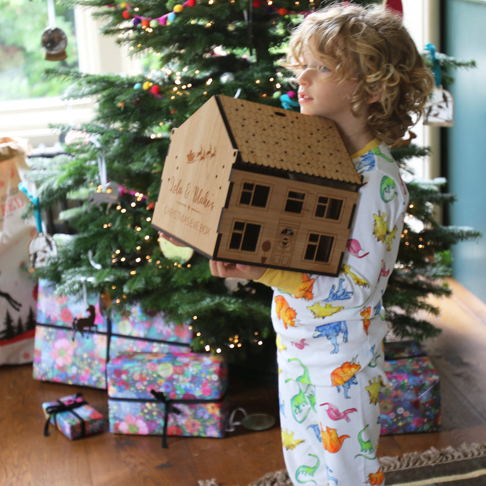 One of the wooden boxes being held by a toddler on Christmas morning.