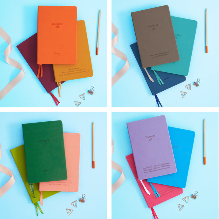 The image shows examples of personalised engraved text on all 12 colours of notebook. The books are stacked in threes and are surrounded by various pieces of stationery.