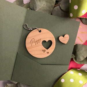 Wooden round decoration with a name and cut out heart