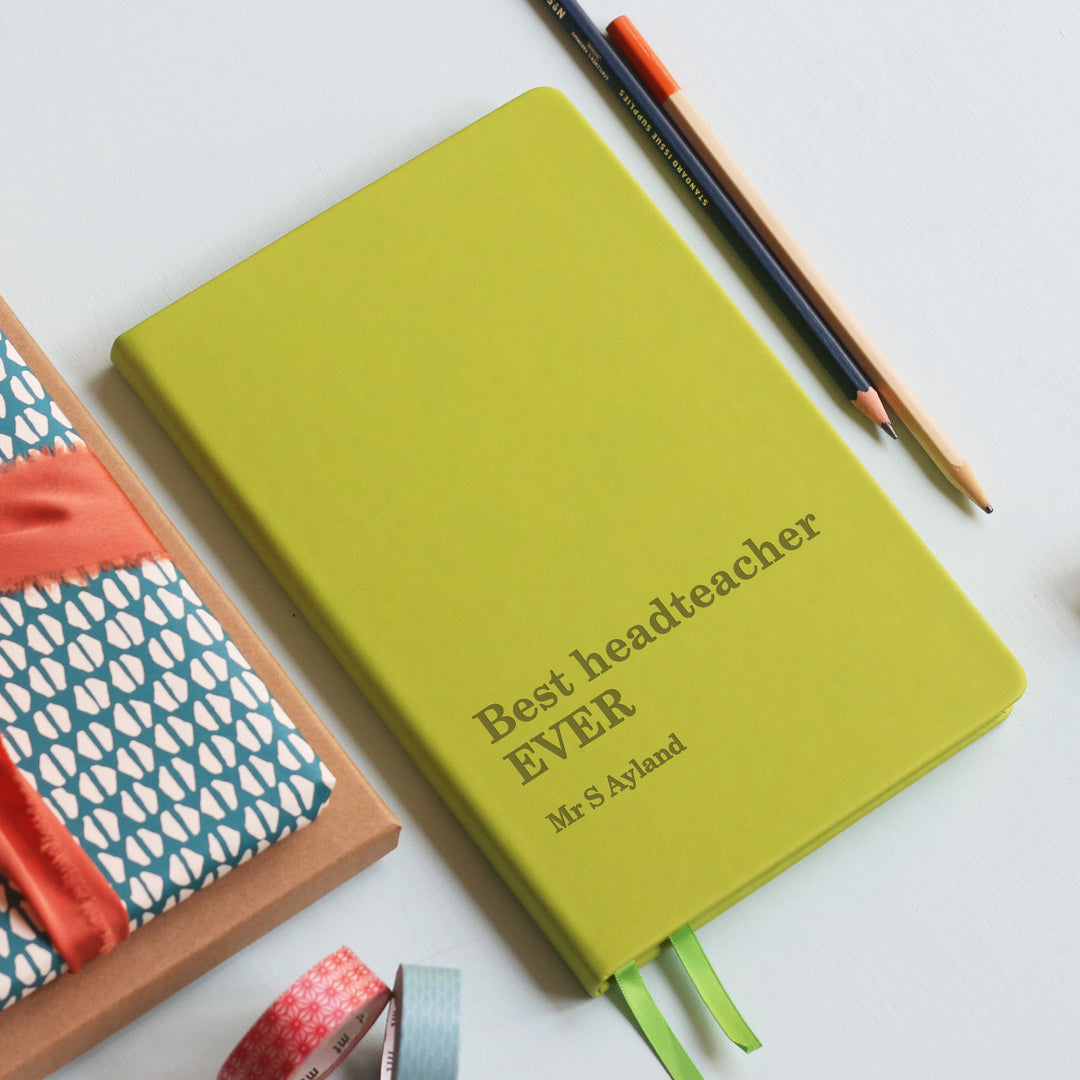 Best headteacher EVER teacher gift  notebook journal lined pages lime green, atop grey background with wrapped book gift and washi tape and pencils.