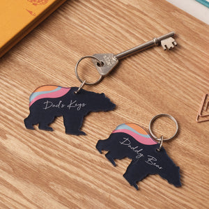 Custom bear-shaped keyring in deep blue with colourful details, presented as a personalised gift for dad.