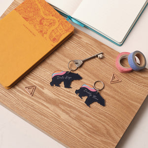 Personalised gift for dad – polar bear keyring with aurora design, styled with stationery on wooden surface