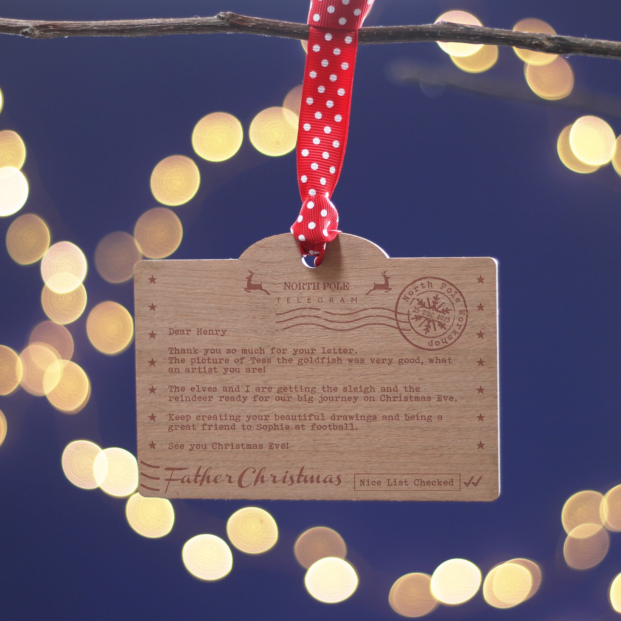 Wooden Santa Claus letter ornament on a Christmas tree