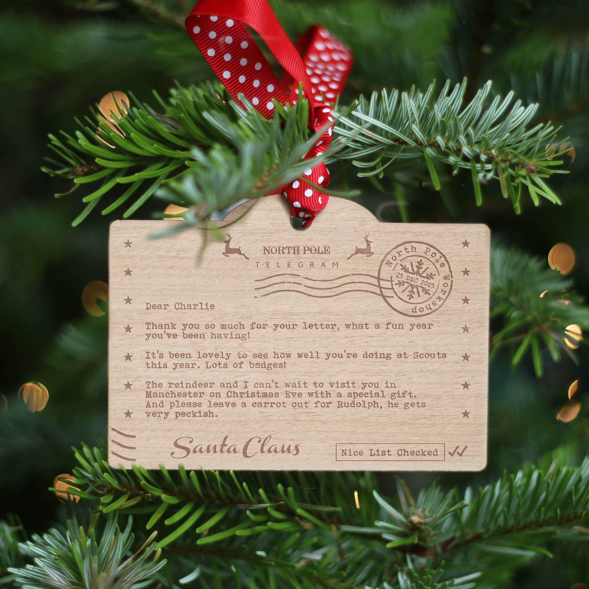 Wooden Santa Claus letter ornament on a Christmas tree