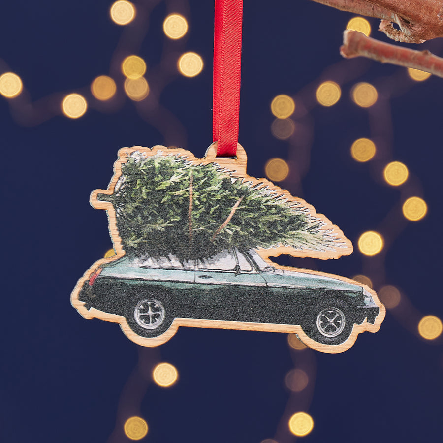 Wooden MG sports car Christmas decoration with festive tree.