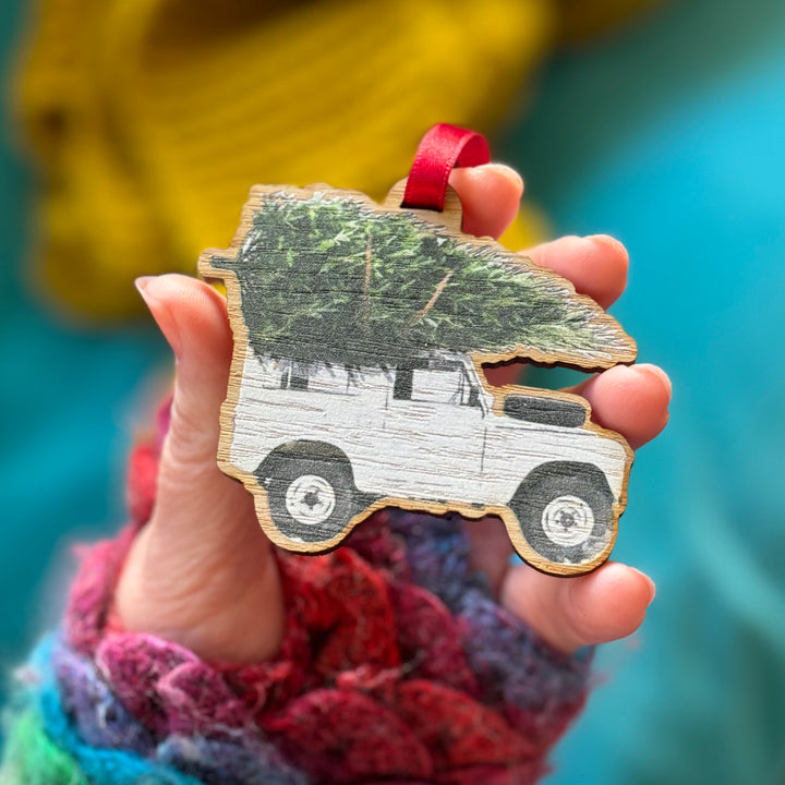 Festive Land Rover truck Christmas ornament in watercolour style.