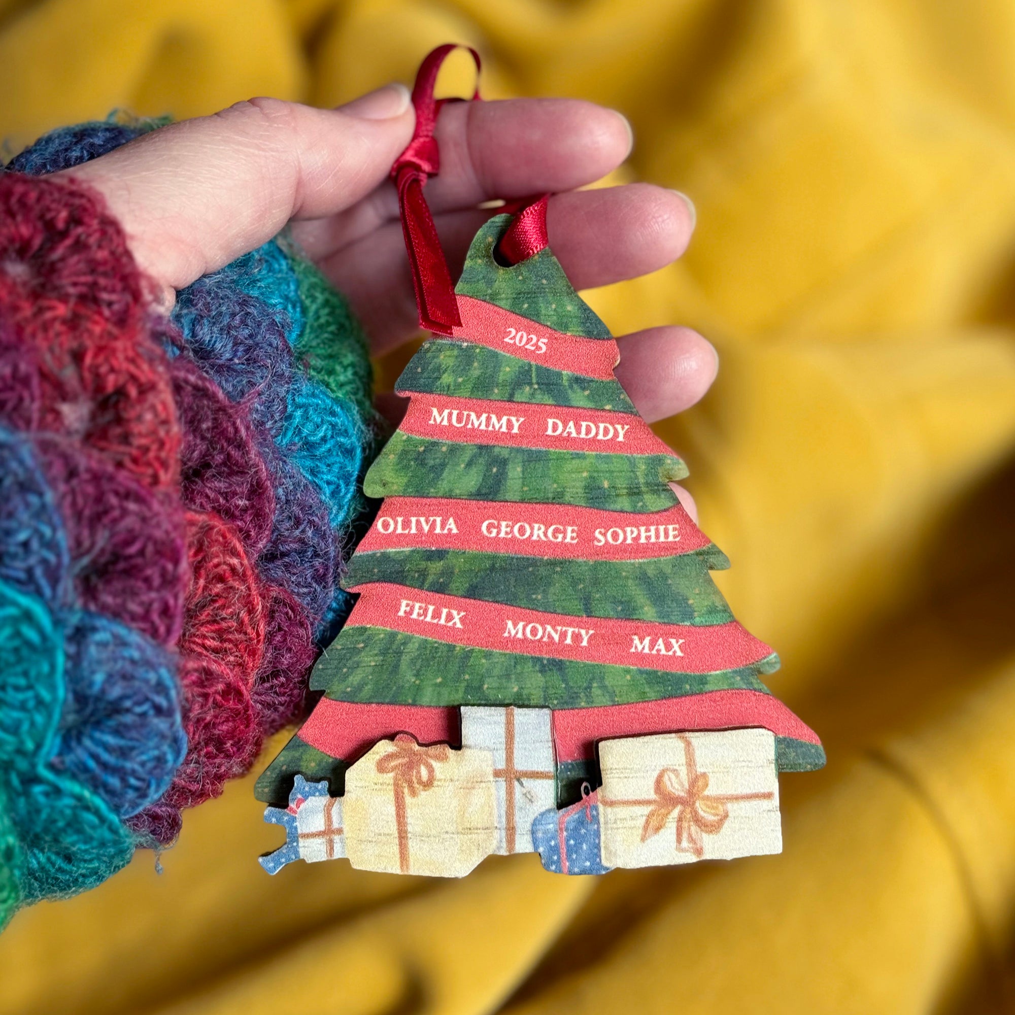 Family name Christmas decoration with layered wood design and printed festive gifts