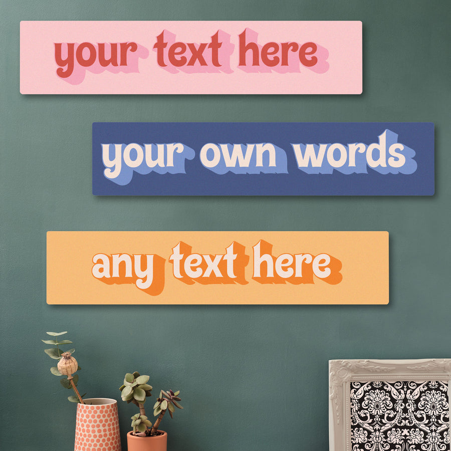 Three colorful rectangular signs with customizable text on a green wall. Retro art print custom words sign. Create your own art