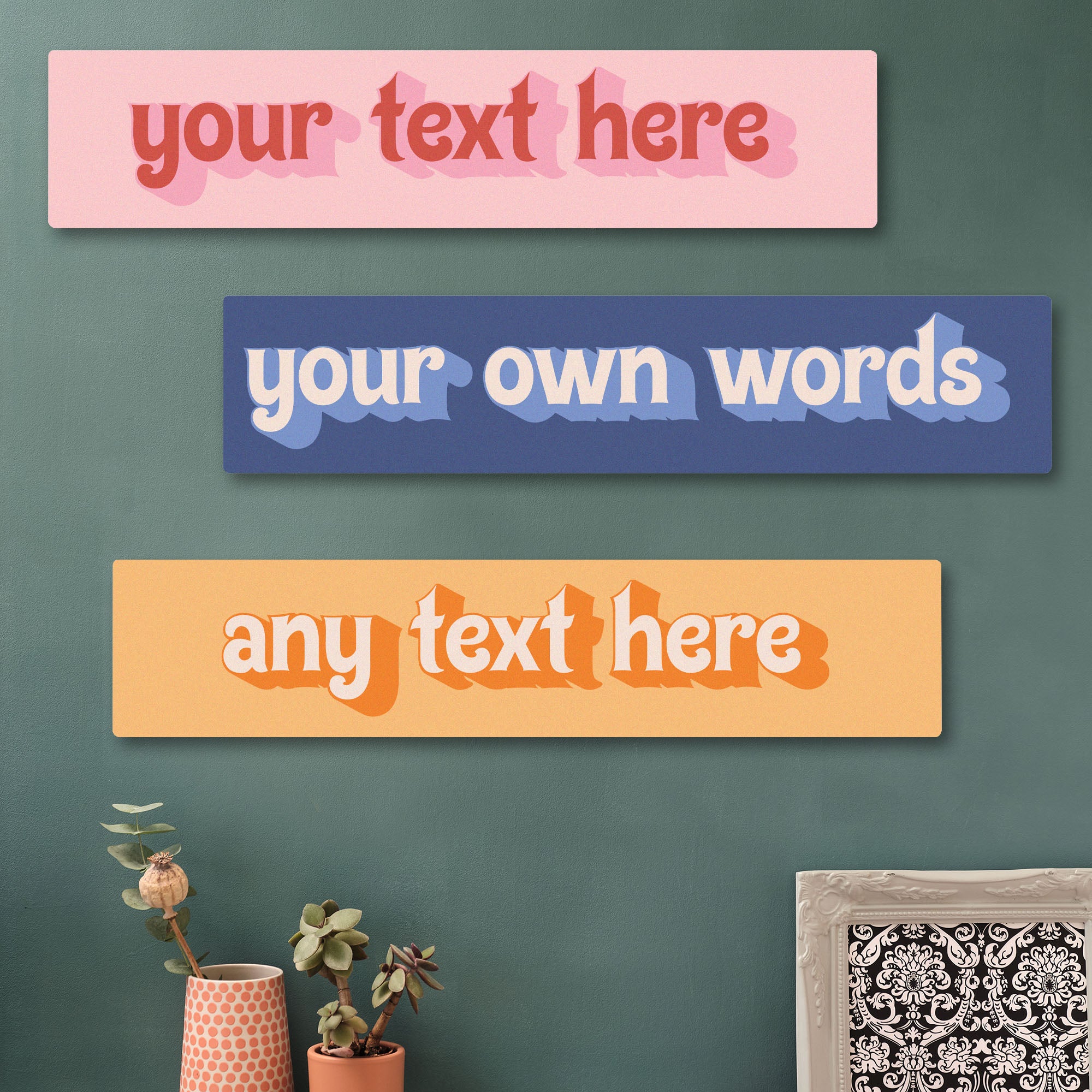 Three colorful rectangular signs with customizable text on a green wall. Retro art print custom words sign. Create your own art