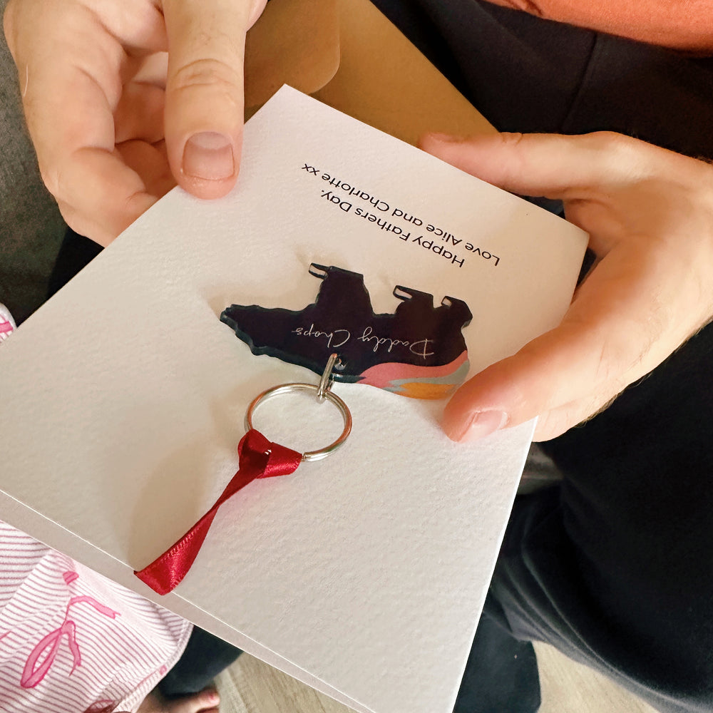 Dad holding a thoughtful first Father’s Day gift – aurora bear keyring with personalised card, perfect for new dads.