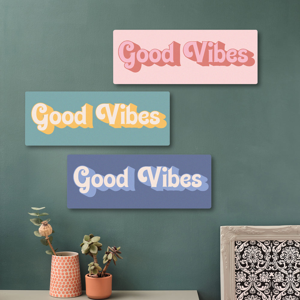 Playful Good Vibes quote print on cherry wood, hanging in a bright hallway with boho decor, perfect for upbeat interiors.