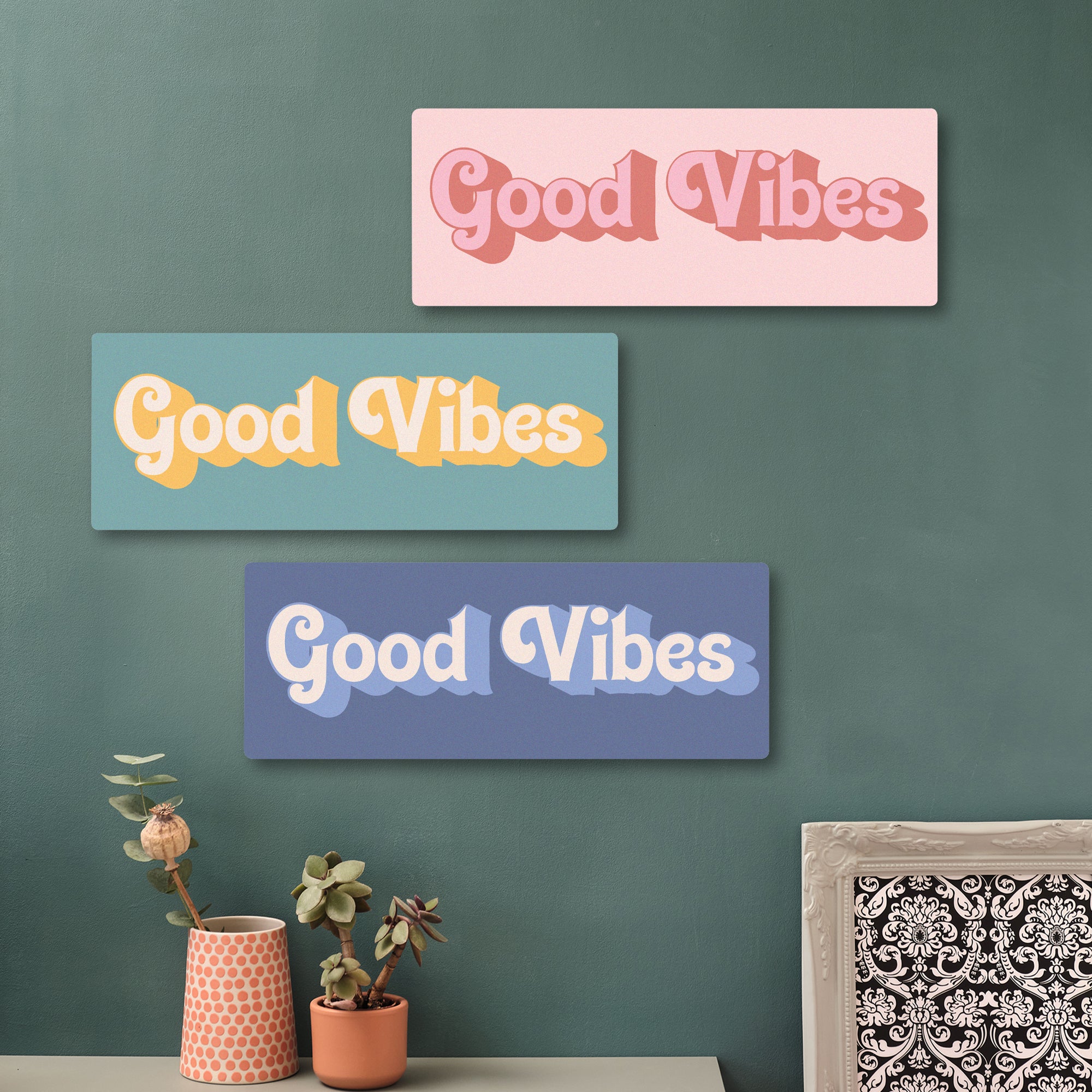 Good Vibes wooden wall art in beachy yellows displayed on a green wall with indoor plants and hexagon decor – perfect for uplifting hallway or home office styling.