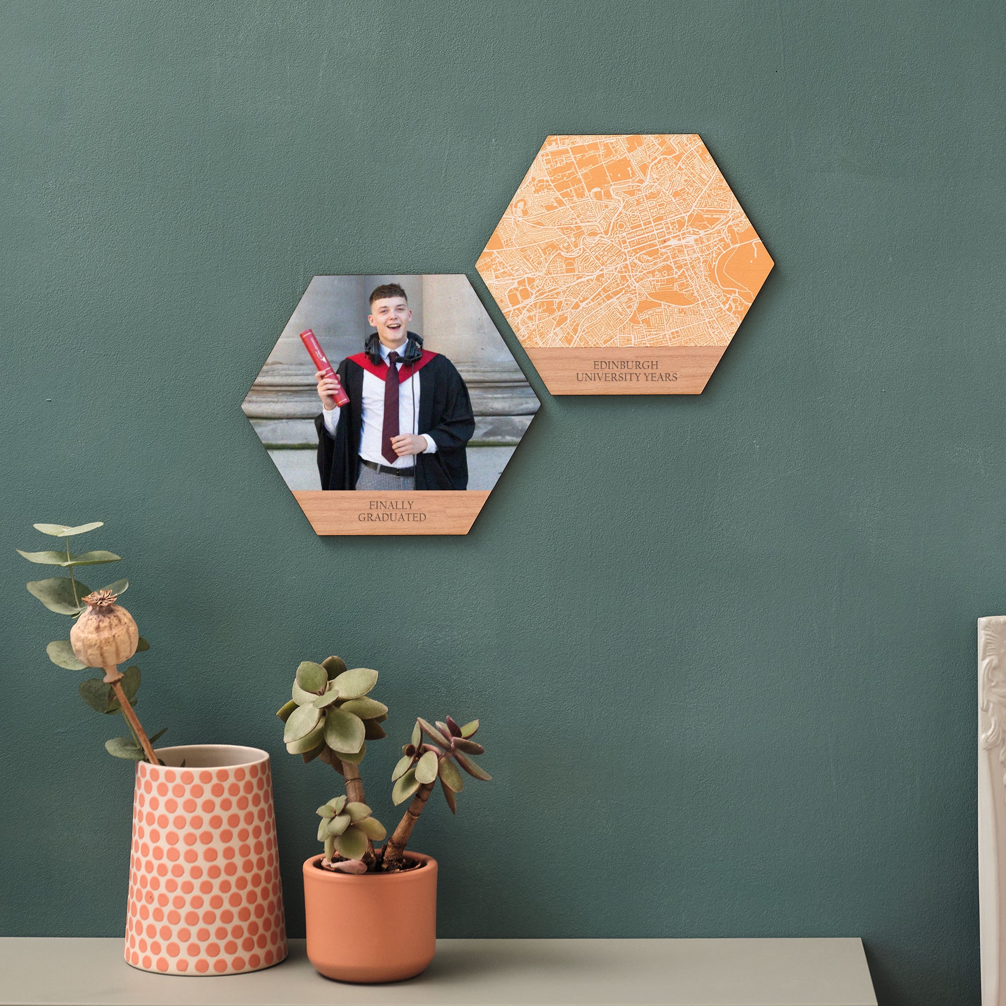 Two hexagons create the perfect graduation keepsake. One shows a young man in gown, holding his degree scroll. One shows a map of Edinburgh University. Displayed on a green wall.