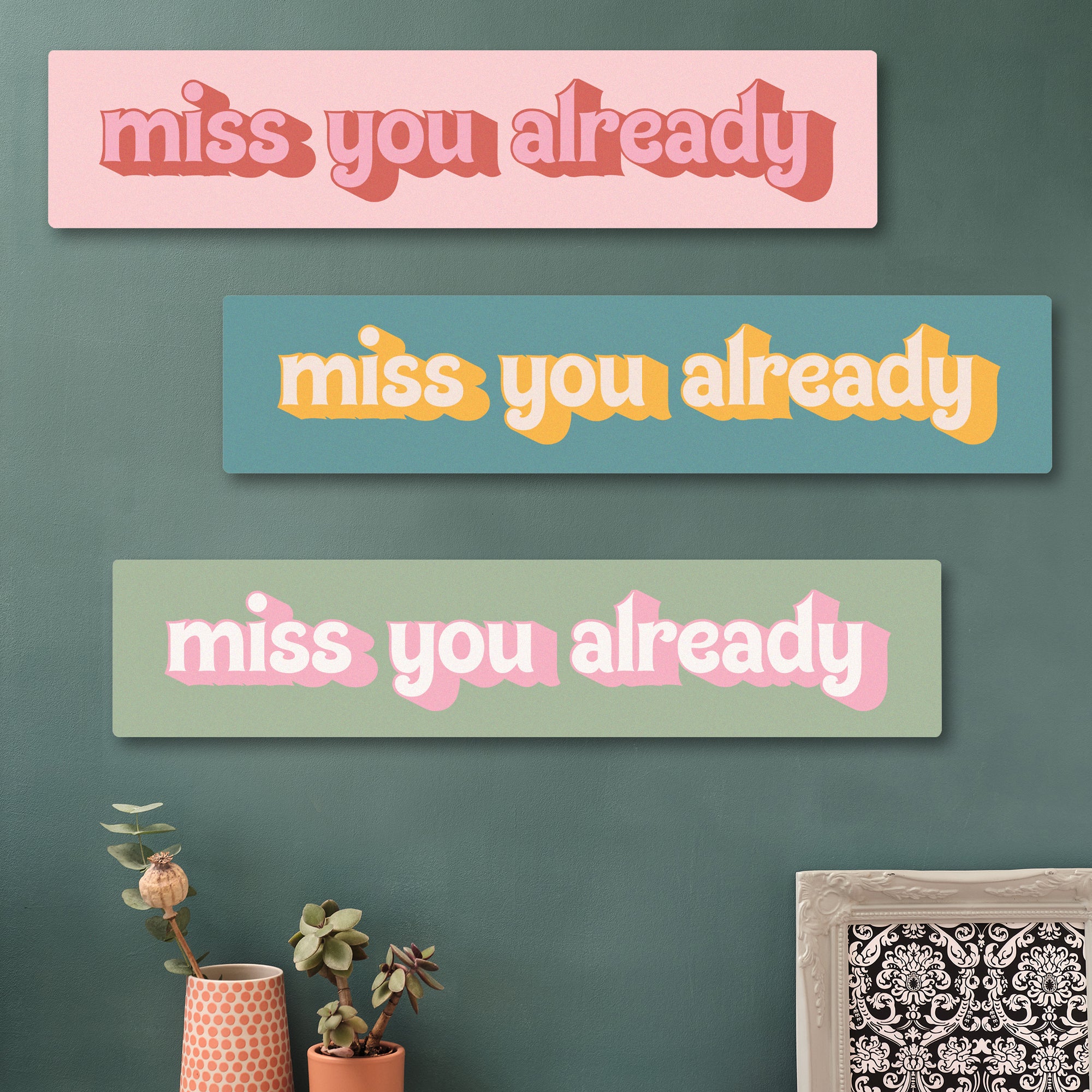 Three Miss You Already wooden art prints in various colours. Statement wooden wall art piece displayed in a colourful entryway, perfect as a leaving gift.