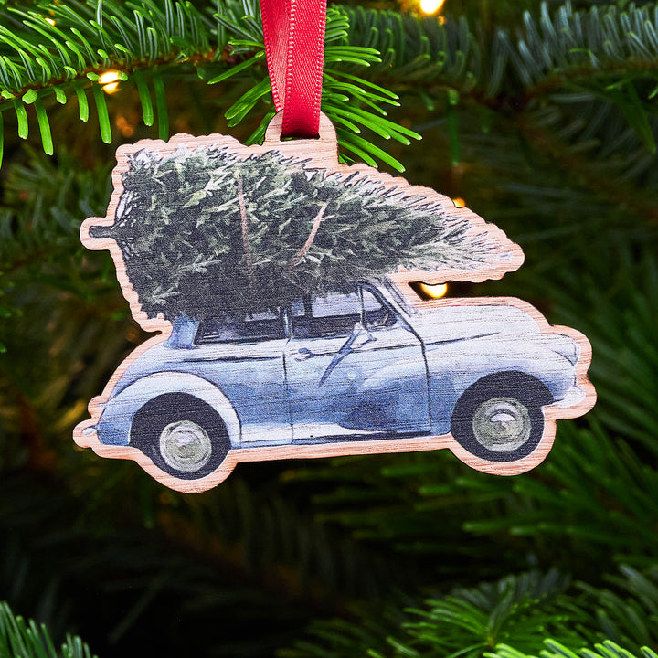 Festive Morris Minor Christmas bauble with red ribbon.