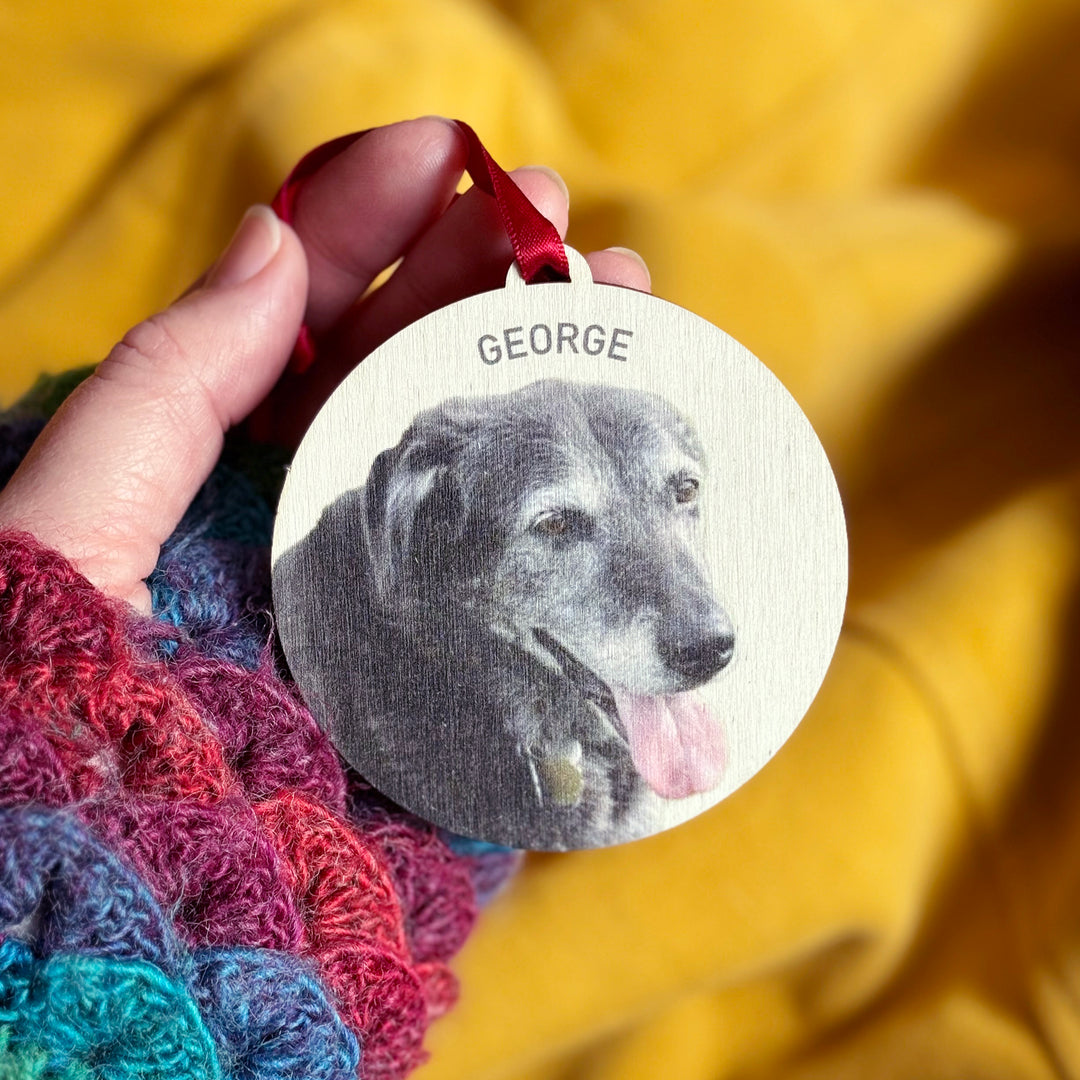 Engraved wooden Christmas dog ornament with name and red ribbon hanger