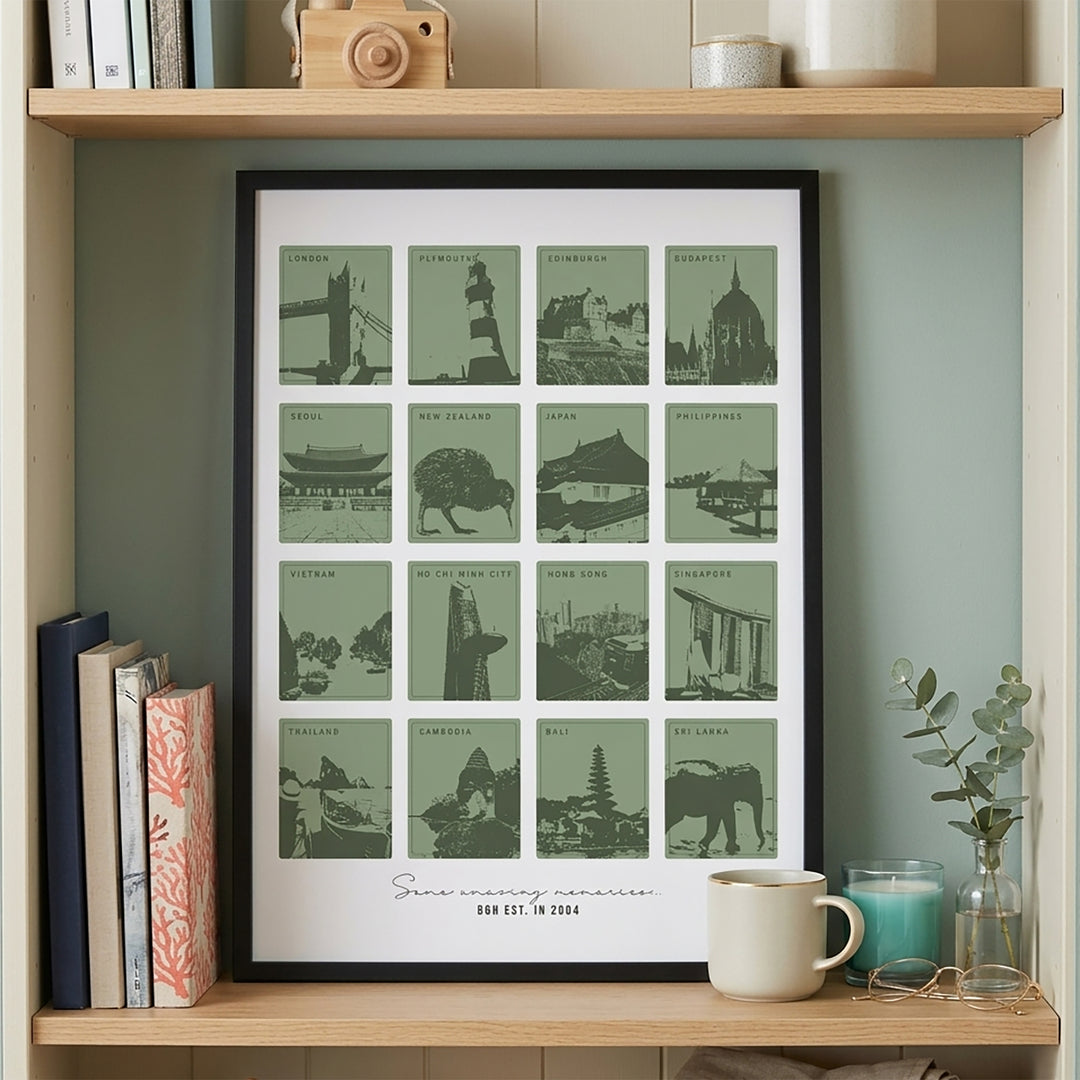 Framed print with green cityscapes on a wooden shelf with books and decor.