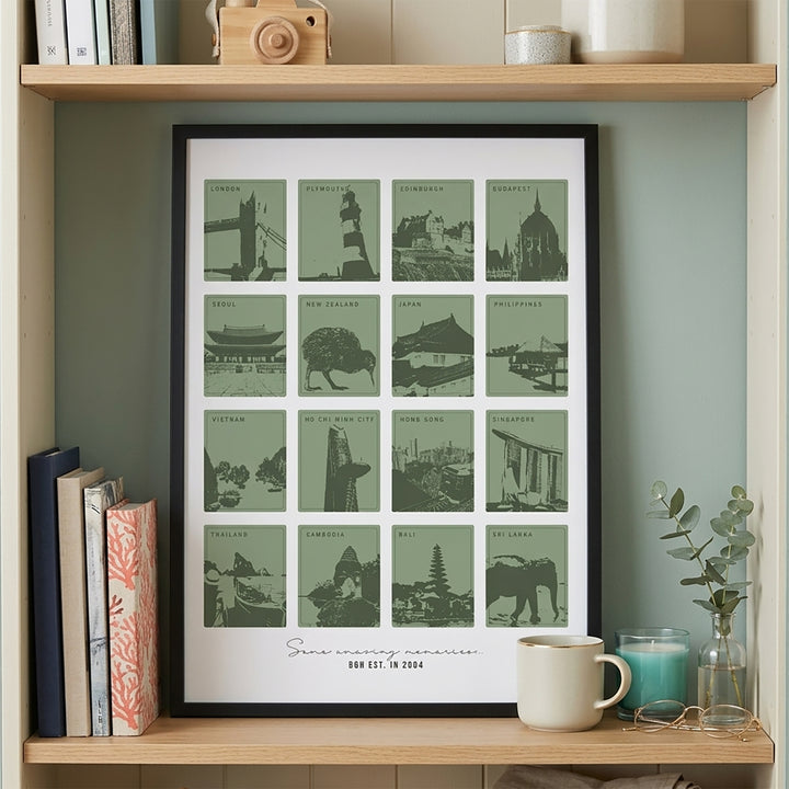 Framed print with green cityscapes on a wooden shelf with books and decor.