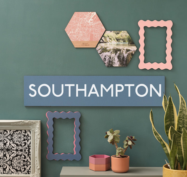Coastal wall wooden decor print, a seaside blue rectangle artwork with the personalised location of 'SOUTHAMPTON' in holiday evocative white text. Ideal gift for holiday rental owners or those with a special seaside travel memory.