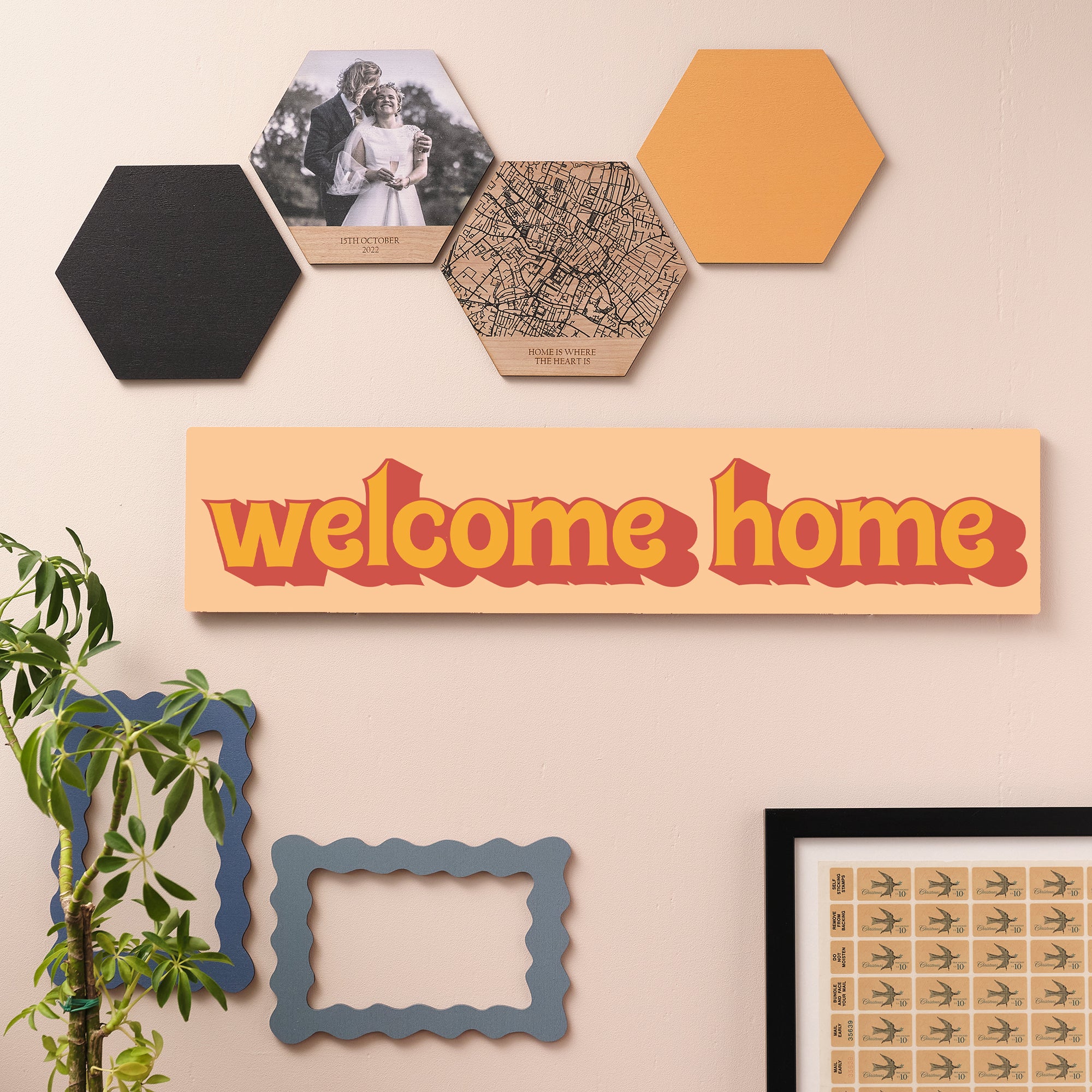 Welcome Home wooden wall sign in bold orange retro font styled on a green wall