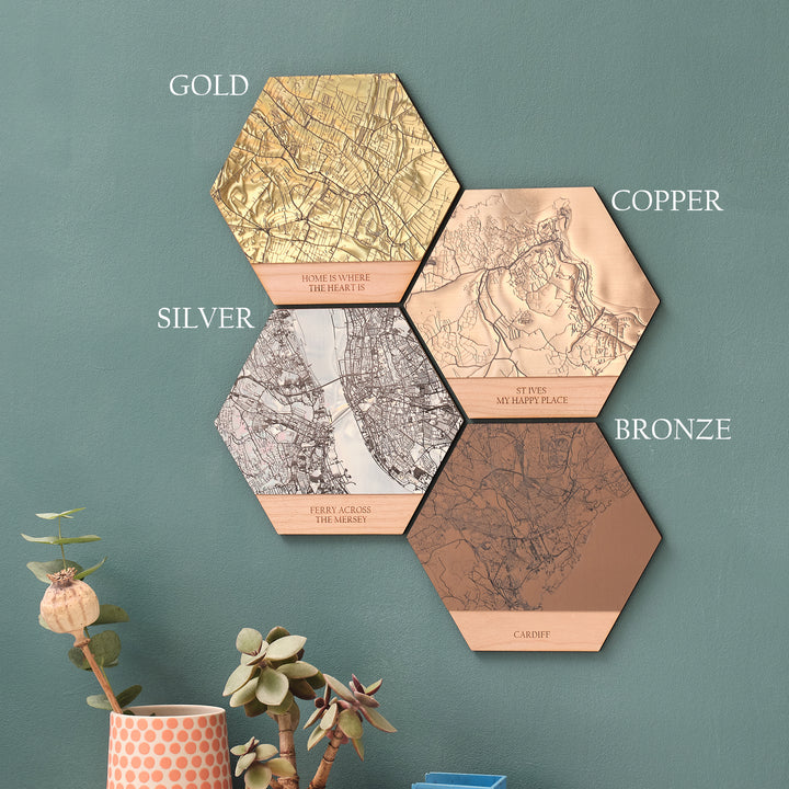 Metallic acrylic options for wooden wall art hexagonal tiles, personalise the text, travel location, and choose from gold, copper, silver or bronze. Great for wedding anniversary gifts. On a green wall.