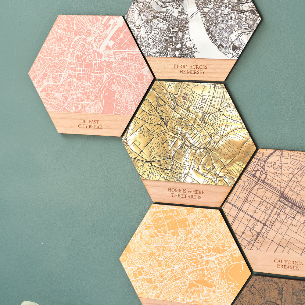 Shining golden home is where the heart is personalised engraved metallic map wooden hall art. Surrounded by tessellated map locations of special destinations perfect for travel lovers or university graduation gift on a green wall! 