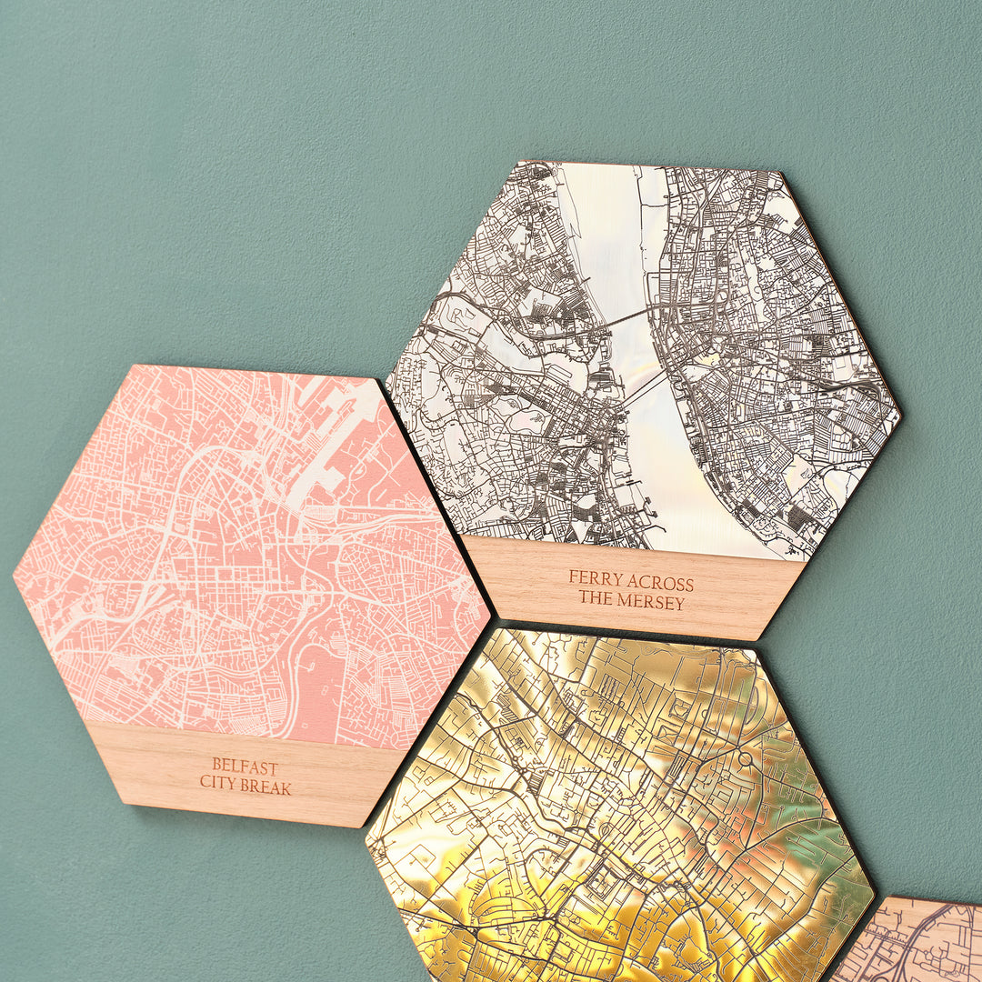 Colourful printed wooden wall art maps and shining golden acrylic travel destination favourite place location gift idea for travellers hung on a green modern maximalist decoration wall.