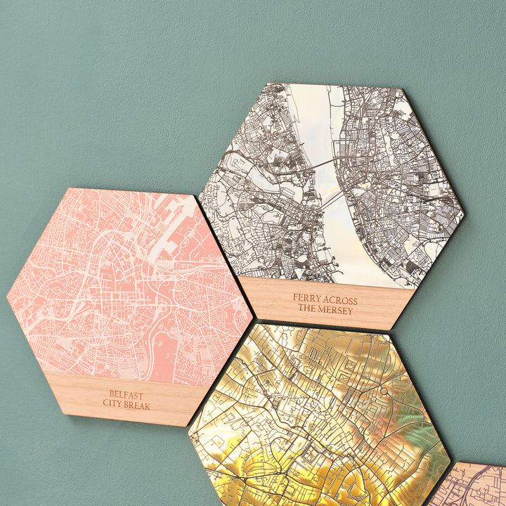 Colourful printed wooden wall art maps and shining golden acrylic travel destination favourite place location gift idea for travellers hung on a green modern maximalist decoration wall.