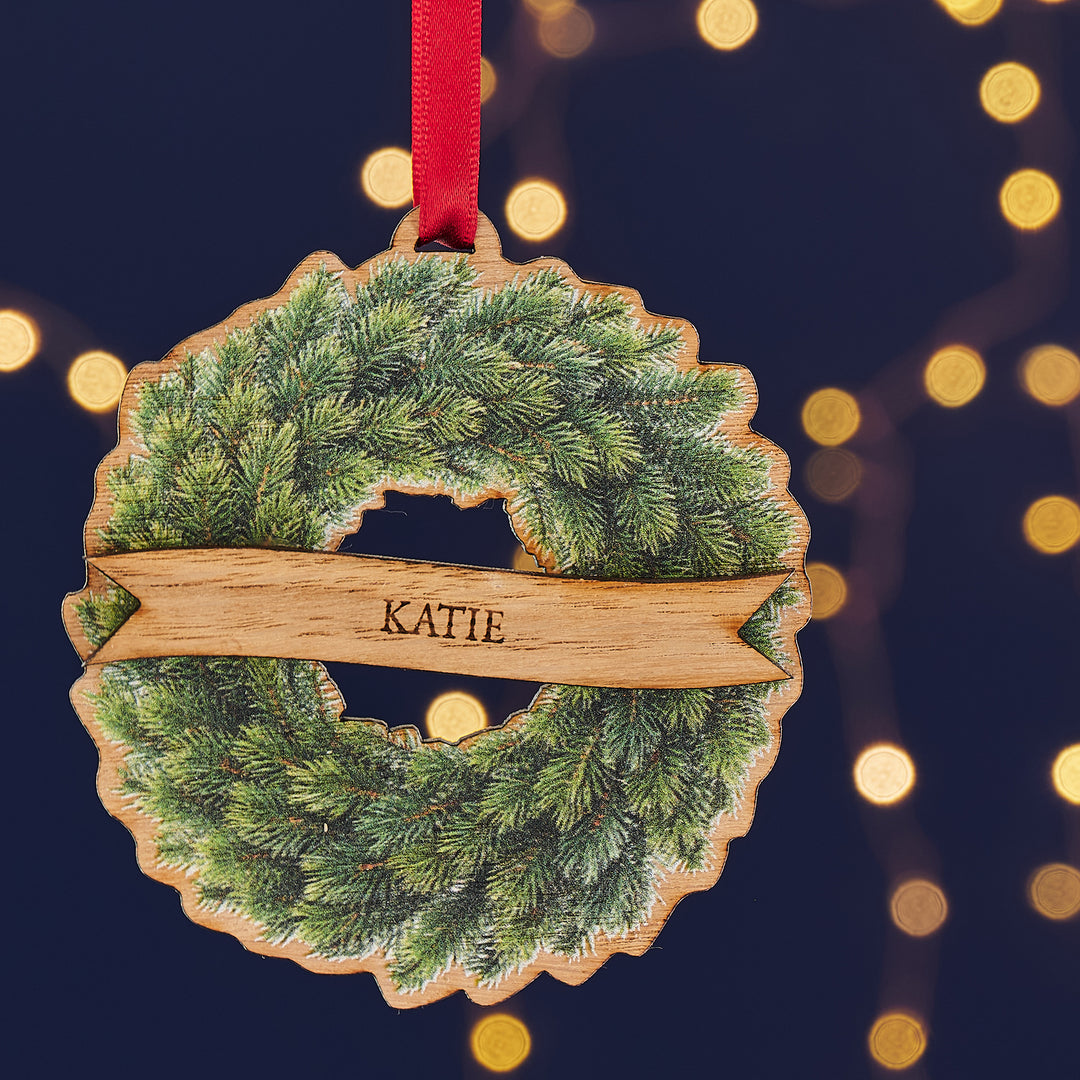Sustainable oak veneer Christmas decoration with traditional printed wreath and engraved ribbon.