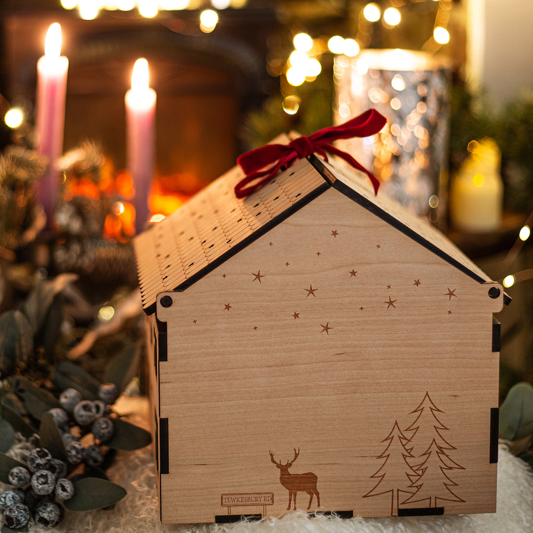personalised wooden house box showing more personalization varieties on the side with a reindeer and road name.
