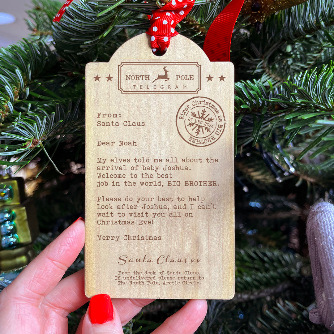 Personalised wooden bauble for proud sibling, engraved from Santa Claus for the family tree.