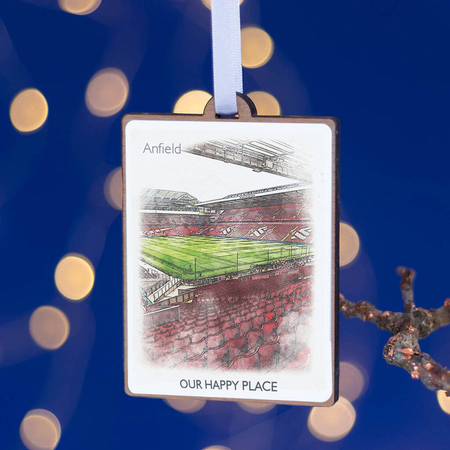A wooden Christmas tree decoration featuring a printed football stadium with the text 'Anfield - OUR HAPPY PLACE' at the bottom.