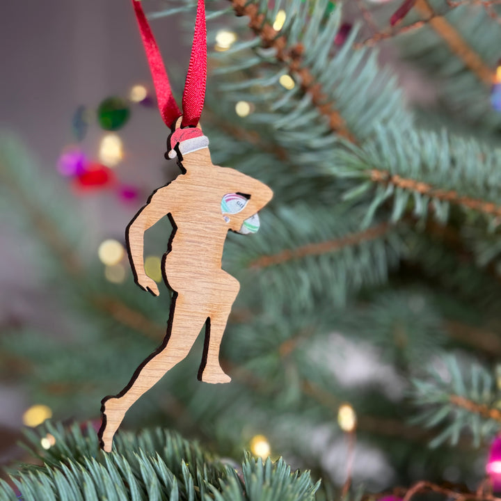 Rugby fan Christmas tree decoration gift wooden silhouette with festive Xmas hat hung on a tree with a red ribbon. 