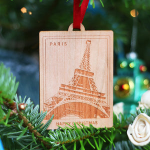 Paris travel memory eco wood custom location Christmas decoration ornament  gift with Eiffel Tower design hung with red ribbon on a Christmas tree. Perfect honeymoon or wedding memory gift for couples or friends. Or to celebrate those lasting family holiday memories.