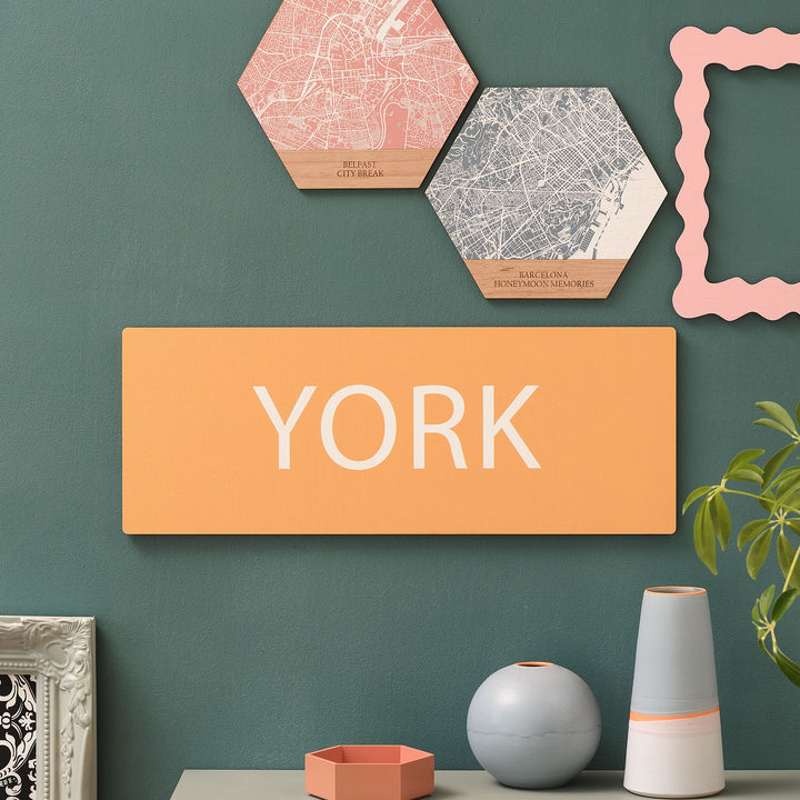 Small size vibrant yellow favourite place gift of city break memory travel destination 'YORK' in white text. Perfect on a maximalist green wall hallway, to match other vibrant art around it.