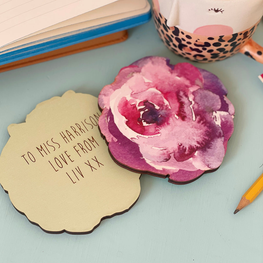 Two wooden coasters, one with a watercolor floral design and the other with a personalized message: "To Miss Harrison, Love from Liv xx."
