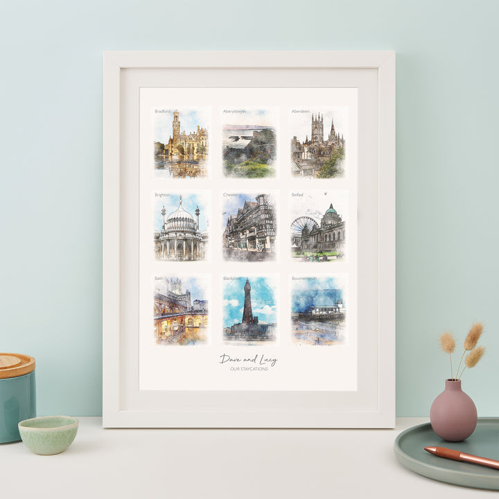 A framed print with nine watercolor paintings of famous landmarks: Edinburgh, York, Chester, Bath, Brighton, Blackpool, Liverpool, Manchester, and Newcastle. The text "Dawn and Lucy" and the year "2019" are written below the images.