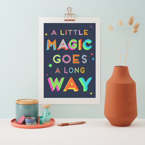 Navy print with the text "A little magic goes a long way" printed in rainbow colours
