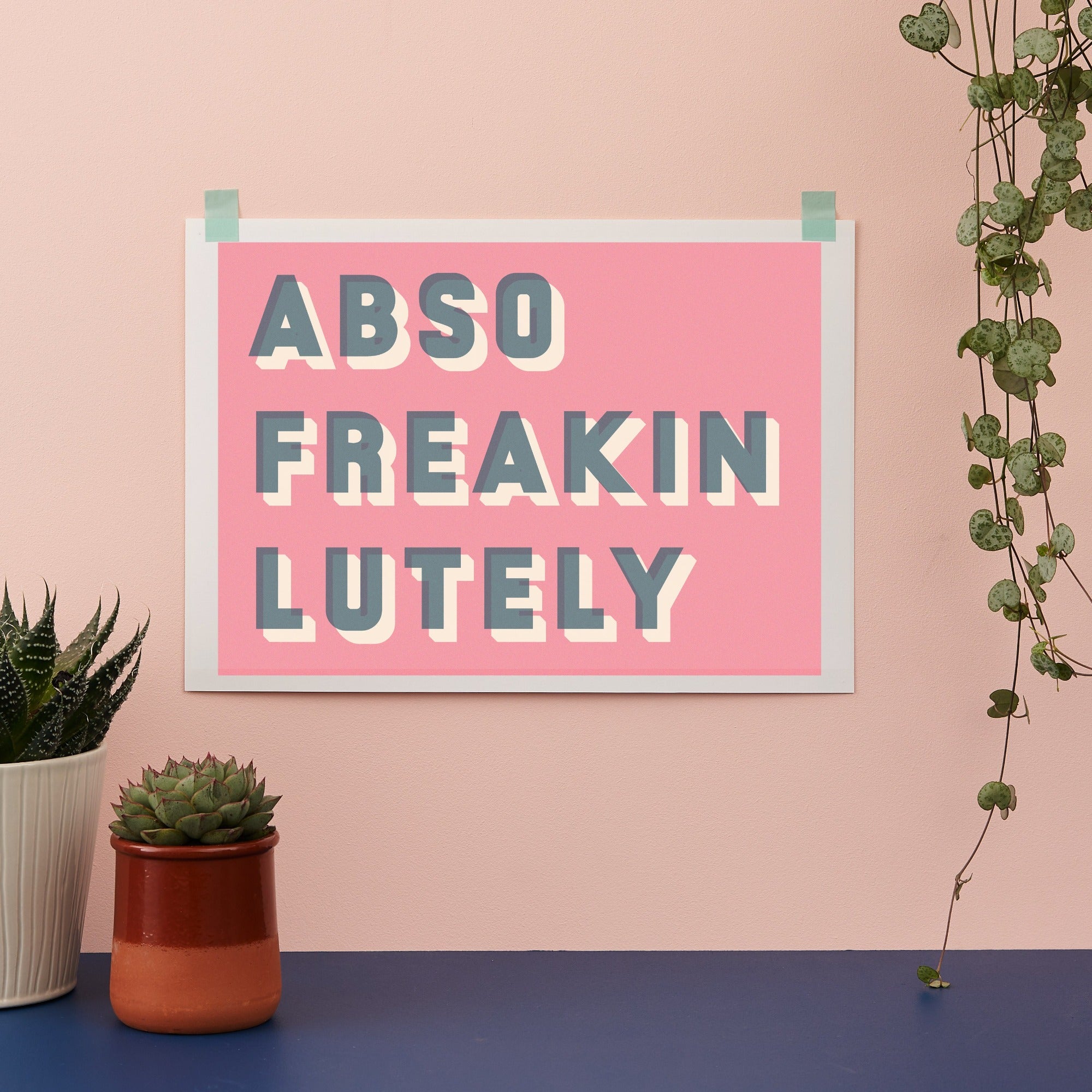 typographic print saying Abso Freakin Lutely on a pink background