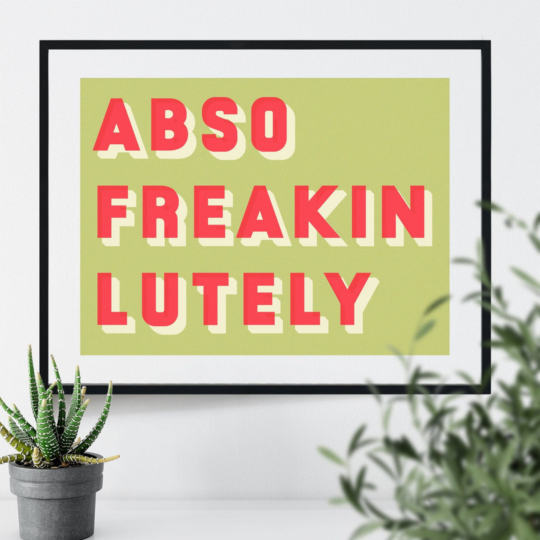  framed typographic print saying Abso Freakin Lutely on a green background