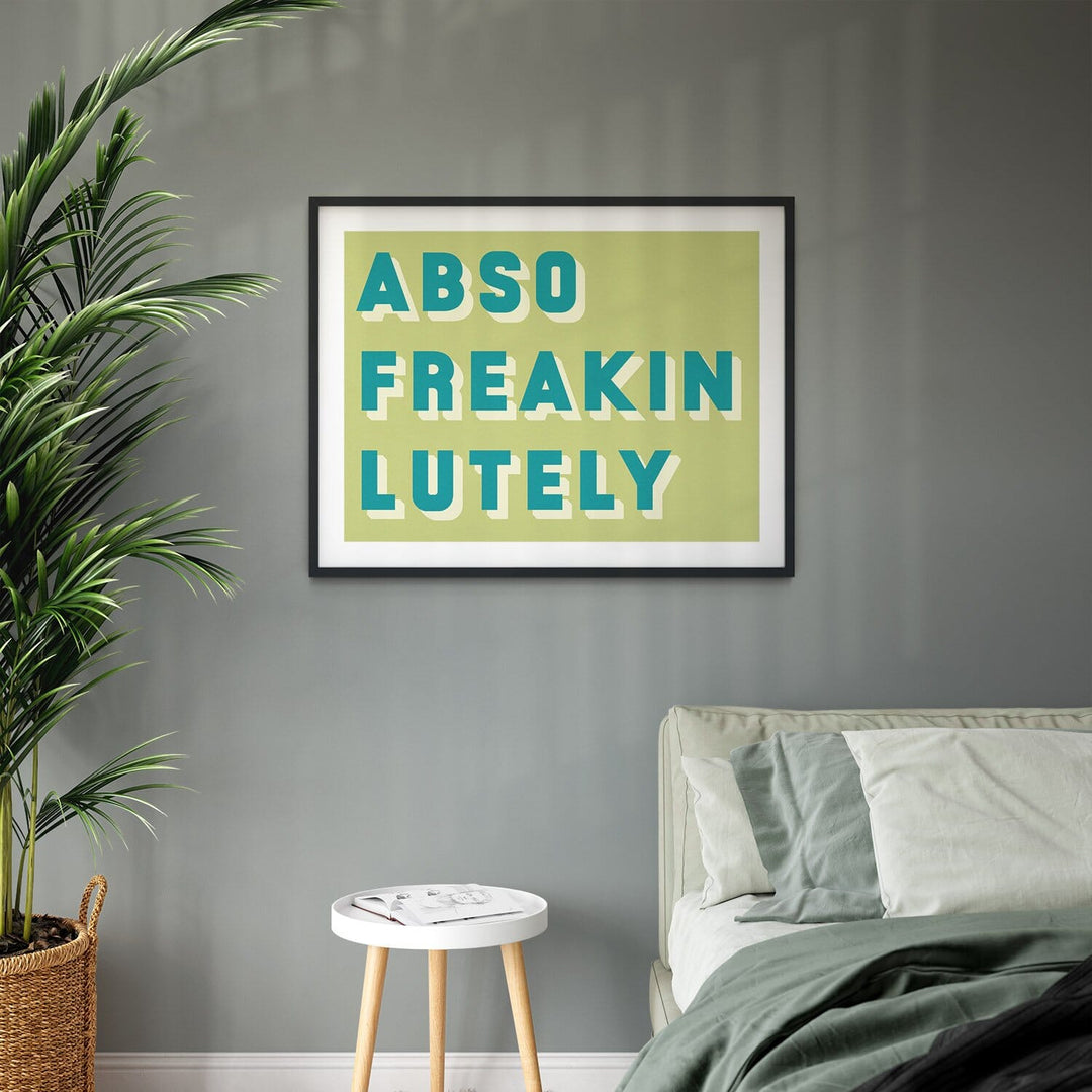  framed typographic print saying Abso Freakin Lutely on a green background