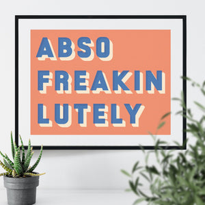 Black framed typographic print saying Abso Freakin Lutely on an orange background