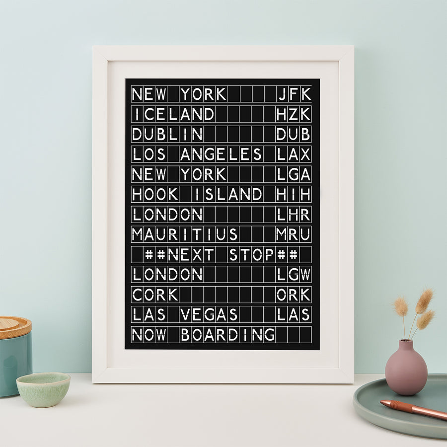 white framed black and white print in the style of an airport departures board