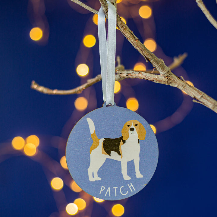 Painted wooden decoration of a beagle dog on a coloured background
