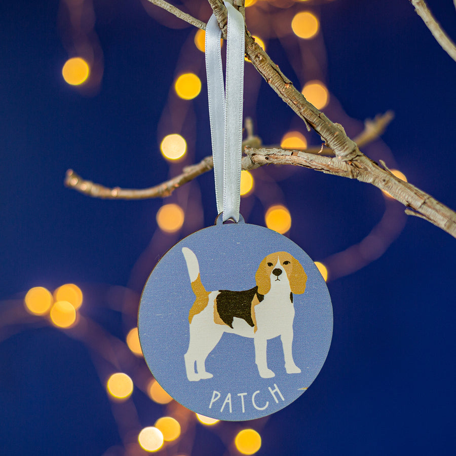 Painted wooden decoration of a beagle dog on a coloured background